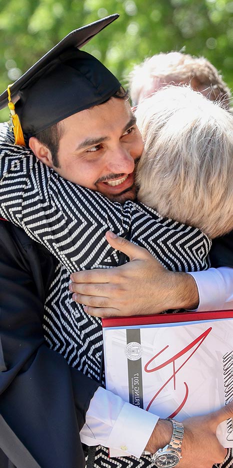 Graduate hugging a family member