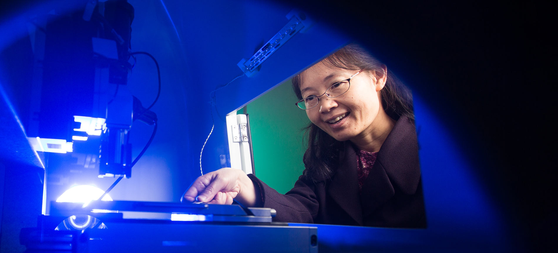 Arkansas faculty member conducting research with advanced scientific equipment